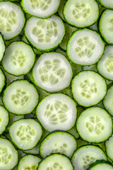 a background of chopped fresh cucumbers for the kitchen.Cucumbers background.Cucumbers for salads or canning. Summer vegetables.