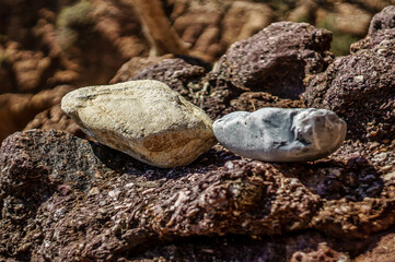 Big stones, sea view and sea scooter. Rock full of curves and smooth cuts resulting from the erosive effect of sea.Stones texture and background. Rock texture.Stone