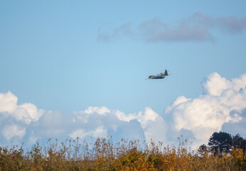  British RAF Lockheed Martin C-130J Hercules aircraft on a military exercise cargo parachute drop run over Salisbury Plain Training Area, UK
