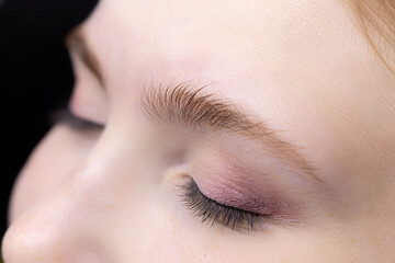 close-up of the eyebrows of a model girl with prepared for the lamination procedure