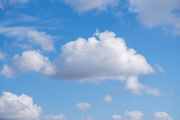 Obraz na płótnie Canvas Bright blue sky with shiny white clouds in the midday