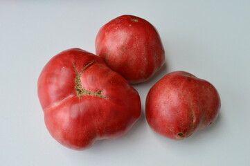 red organic tomato on a white background