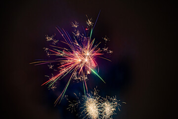 Colorful Fireworks, red blue green and gold, long exposure, horizontal format