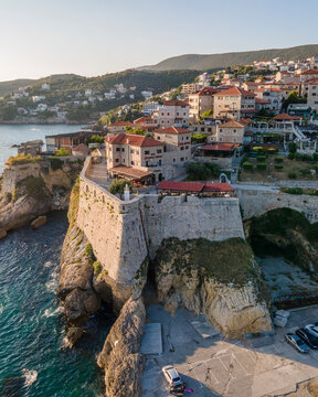 Aerial view of Ulcinj, a small town on a rocky promontory along the Mediterranean coastline in Montenegro during sunset.