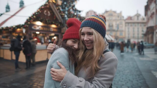 Lesbian couple in love at xmas eve. Prague old town square. Pride, lgbt, love, friendship, christmas, holiday, vacation concept.