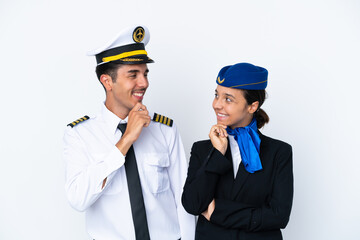 Airplane pilot and mixed race air hostess isolated on white background looking looking at each other