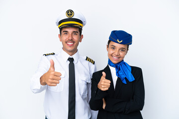 Airplane pilot and mixed race air hostess isolated on white background giving a thumbs up gesture because something good has happened