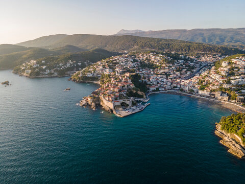 Aerial view of Ulcinj, a small town on a rocky promontory along the Mediterranean coastline in Montenegro during sunset.