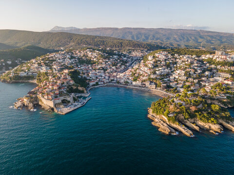 Aerial view of Ulcinj, a small town on a rocky promontory along the Mediterranean coastline in Montenegro during sunset.