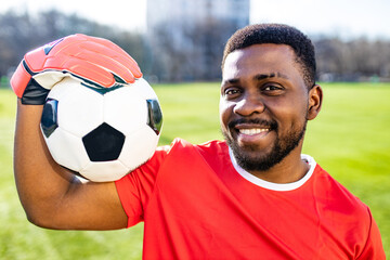 brazilian man goalkeeper catches the ball in the stadium during a football training