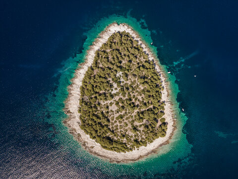 Aerial view of Otocic Smokvica island, a small desert and paradise island near Primosten shoreline, Sibenik province, Croatia.
