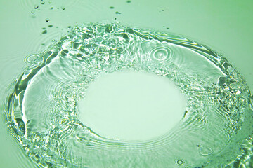 Transparent green colored clear water surface texture with ripples, splashes and bubbles. Nature...