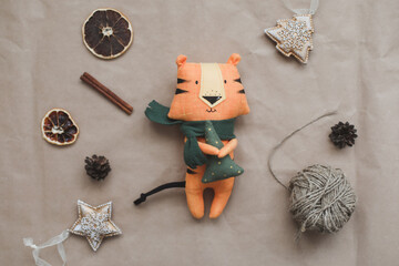 Christmas composition with a tiger toy, symbol of new 2022, a gift, fir tree branches and decorations. Christmas, winter, new year concept. Flat lay, top view