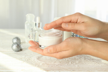 Composition with winter cosmetic products on white wooden table