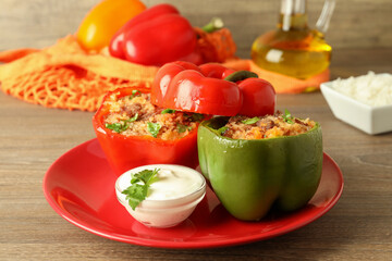 Concept of tasty food with stuffed pepper on wooden table