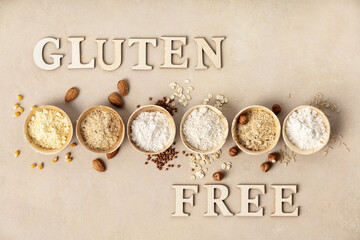Various gluten free flour almond flour, oatmeal flour, buckwheat flour, rice flour, corn flour and gluten free lettering made of wooden letters