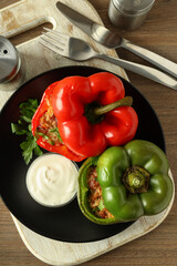 Concept of tasty food with ​stuffed pepper on wooden background