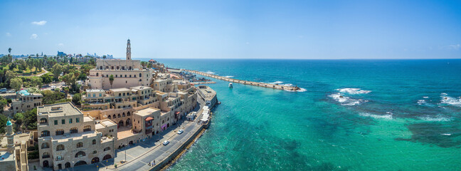 Panoramic Aerial view of a tourists ship enters the old Jaffa harbour and the surrounding buildings, Tel-Aviv Jaffa, Israel.