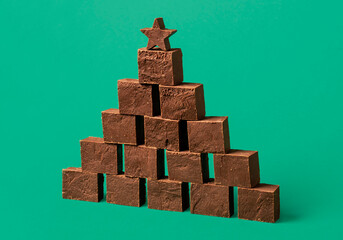 Chocolate fudge pile, on a green background.