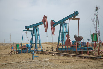 Land oil drilling rig blue sky .Land rig during the drilling operation . Oil and gas drilling rig onshore dessert with dramatic cloudscape .