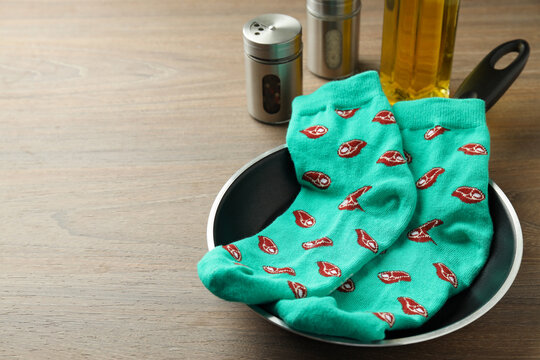 Cooking concept with socks with meat slices on wooden background