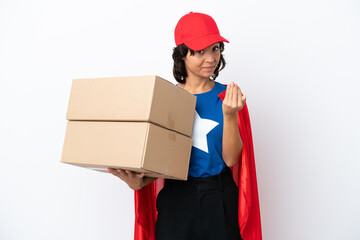 Young superhero delivery girl isolated on pink background inviting to come with hand. Happy that you came