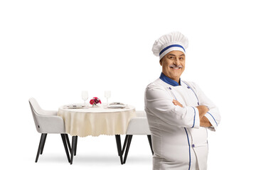 Male chef posing in front of a restaurant table