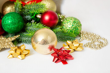 Christmas background with fir branches, red and gold decorations on a white background. Flat lay. top view with copy space