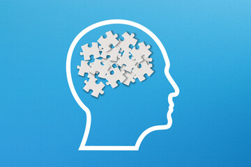 Confusion concept, mental health and problems with memory. Human brain shaped made of white jigsaw puzzles inside your head