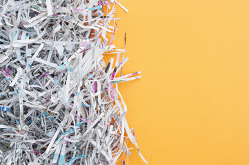 The shredded paper on light orange background.