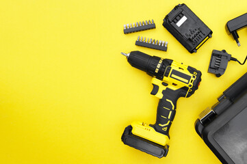 The yellow-black screwdriver on a yellow background, a set of bits.