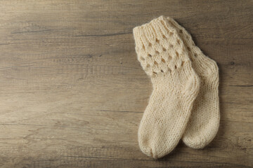 Pair of woolen socks on wooden background