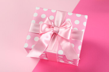 Pink gift box on two tone background