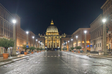 The illuminated St. Peter's dome in Vatican City late evening after a short rainfall.