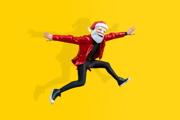 Fototapeta na wymiar Man with funny low poly Santa Claus mask on colored background