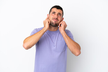 Young handsome caucasian man isolated on white background frustrated and covering ears