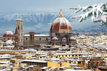 The famous Cathedral of Santa Maria del Fiore in Florence with the Dome covered with snow in...