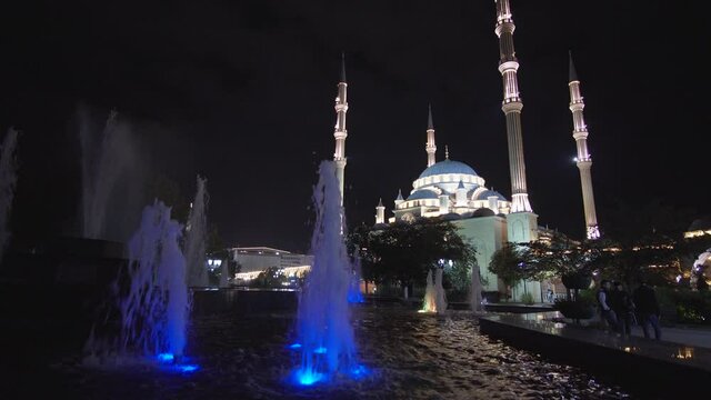 Multicolored fountain in front of a mosque in the center of Grozny at night, Chechen Republic