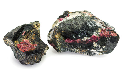 Two pieces of rock interspersed with the mineral eudialyte on a white background