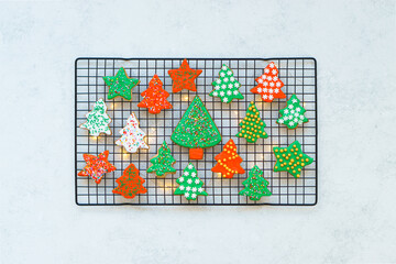 Beautiful bright cookies in the form of Christmas trees prepared for the holiday of Christmas and New year. Background, top view, Festive cookies on a light background.