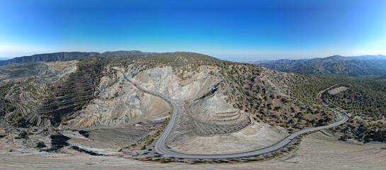 Aerial top drone view mountain landscape with empty curved road.