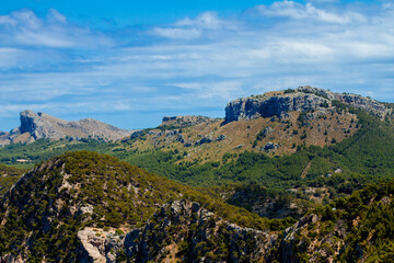 Fototapeta na wymiar Landscape with mountains and sky, view of cliffs and green hills in Spain, Mallorca