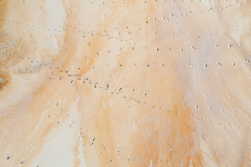 Beautiful orange texture on the ground, a view from a great height, an old flooded quarry. Rusty...