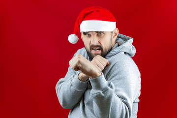a bearded man in Christmas clothes clenched his fists and stood in a fighting stance waiting for the holiday