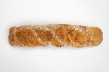 whole baguette isolated on white, top view
