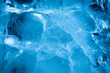 Extremely cold background with cracked ice. Wallpaper for a winter card, unique blue ice pattern fine details.