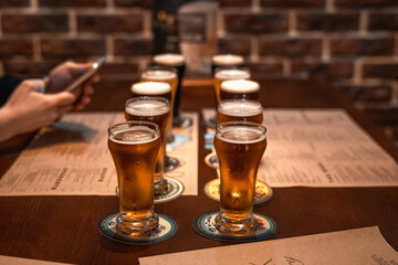 glasses of beer on the table in pub bar