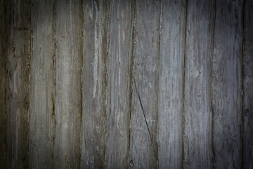 Wooden logs of an old house. Close-up. Weathered natural gray wood texture. Background. Horizontal photo.