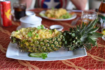 fried rice with shrimp in pineapple. Delicious carved pineapple served as a bowl container boat stuffed with fresh pineapple tomato sauced seafood fried rice. Fried rice in pineapple