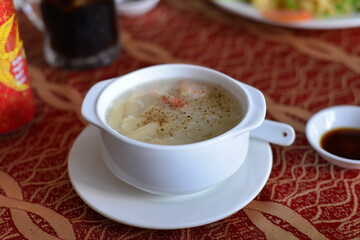hai Dishes - Soup made from Coco Milk and Mushrooms and Chicken Meat. Creamy soup with chicken and vegetables. Vegetable cream soup with shrimps and croutons in bowl. 